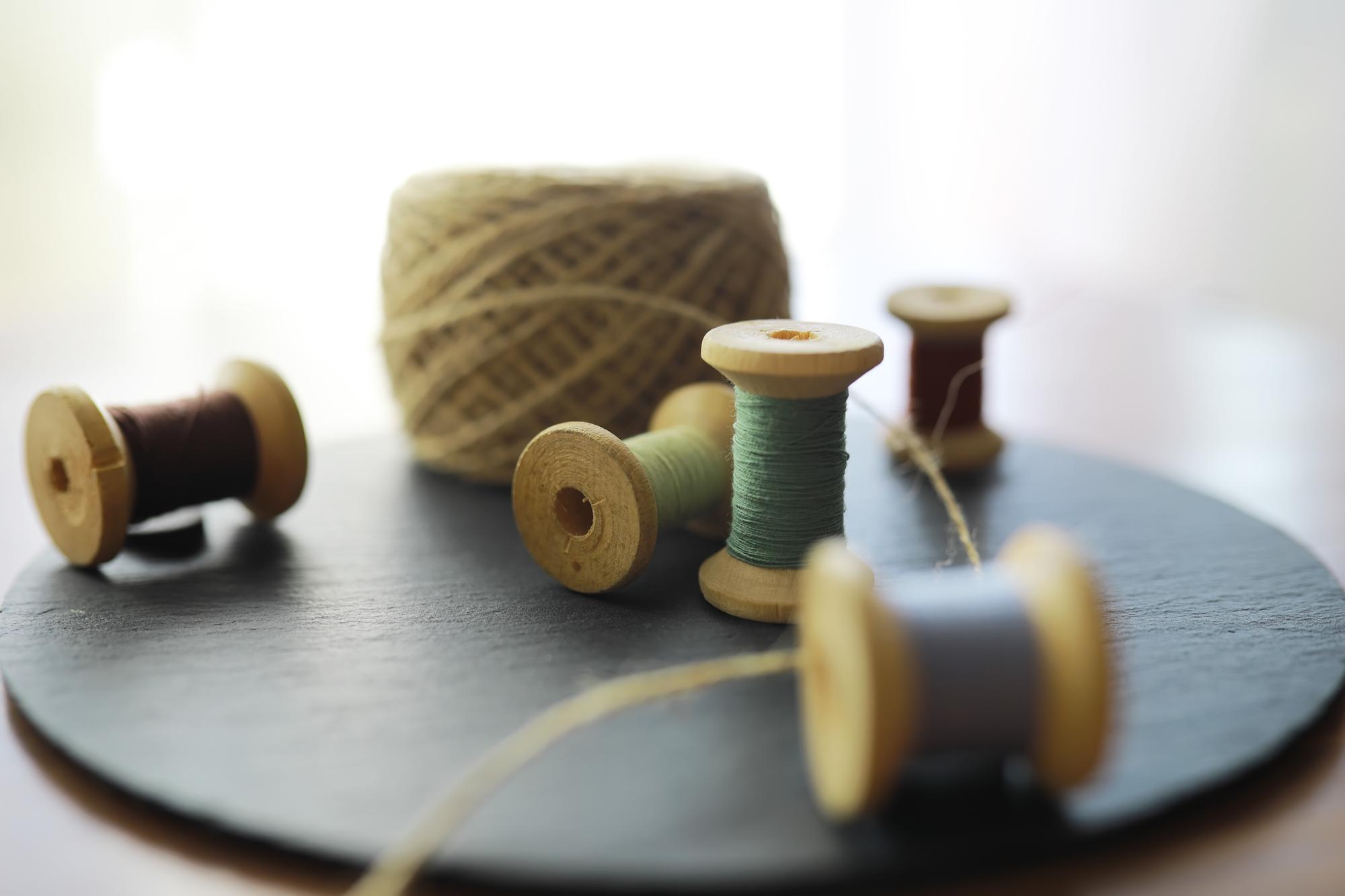 Workshop table with thread spools and machine