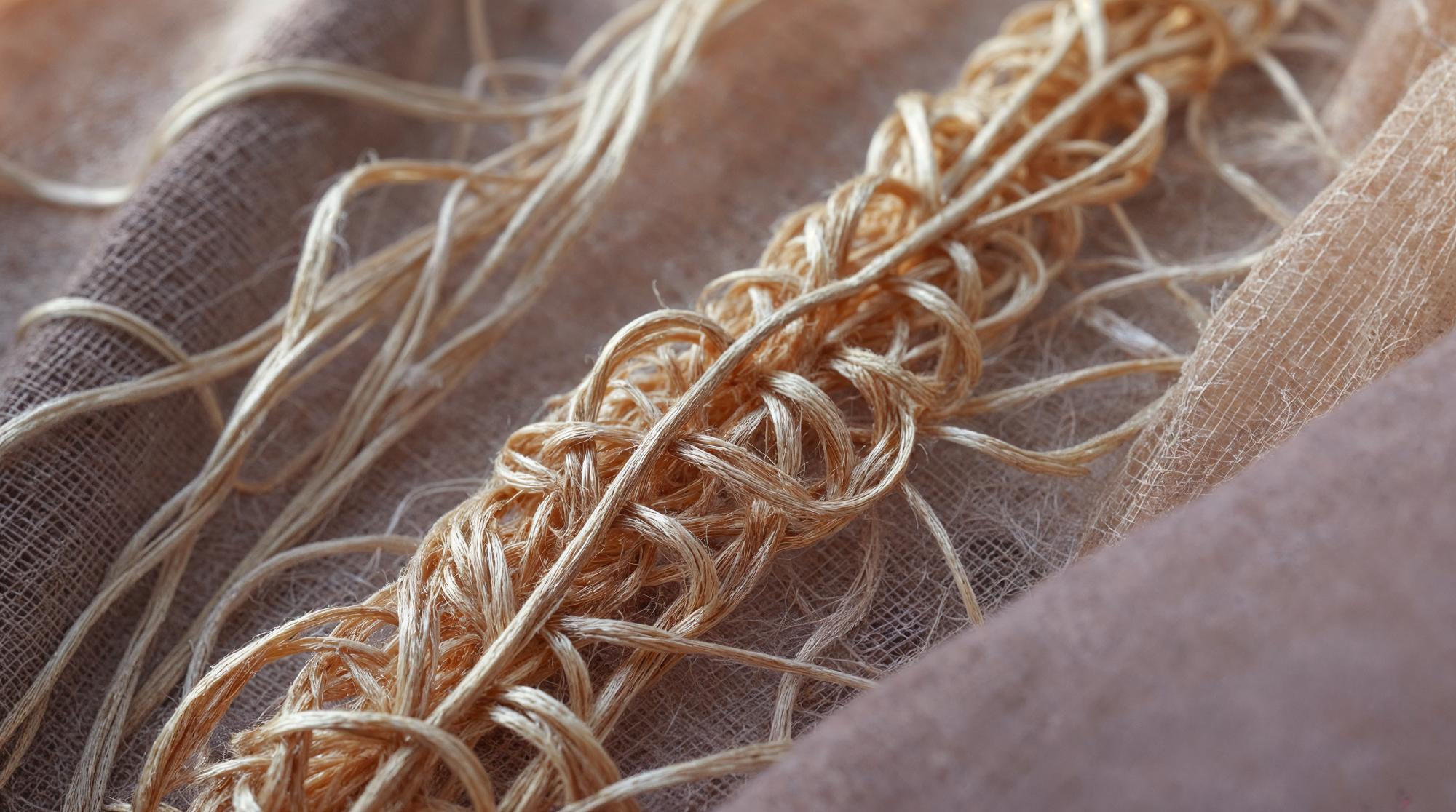 Close-up gold thread embroidery on linen