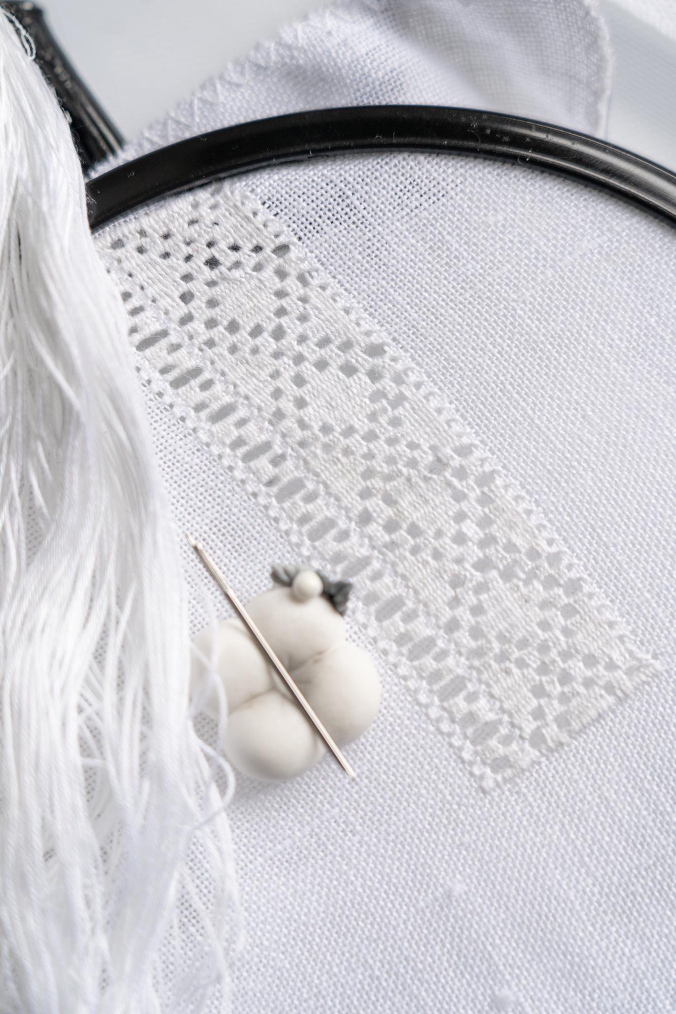 Row of embroidered samples on table